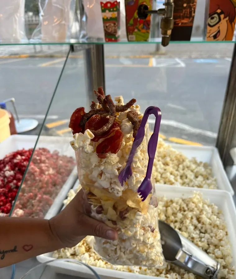 Copo de pipoca gourmet com calda e confeitos